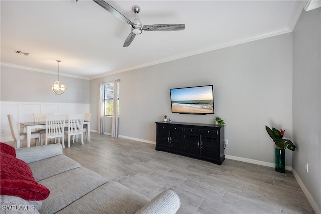 living room featuring ceiling fan, baseboards, visible vents, and crown molding