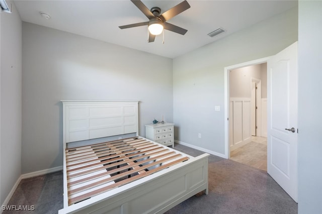 unfurnished bedroom featuring a ceiling fan, baseboards, visible vents, and carpet flooring