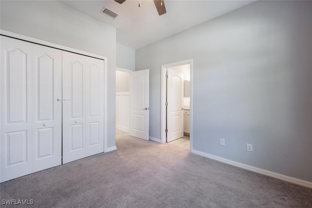 unfurnished bedroom featuring light carpet, baseboards, visible vents, ensuite bathroom, and a closet