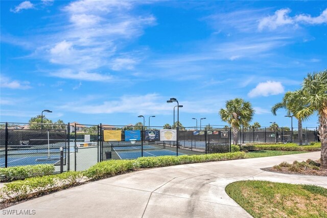 view of tennis court featuring fence