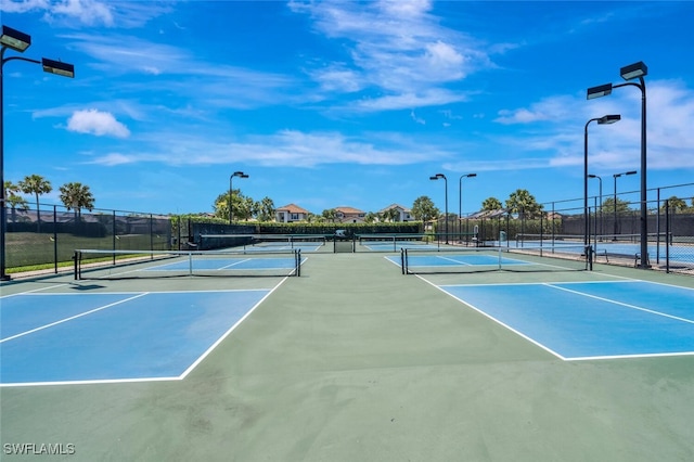 view of sport court featuring fence