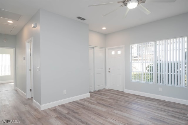 foyer with light hardwood / wood-style floors and ceiling fan