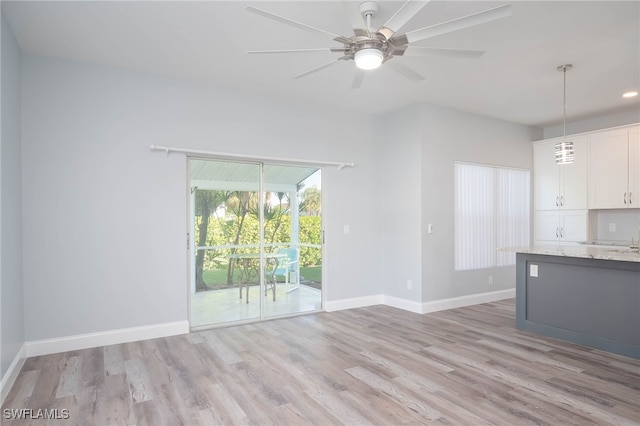 unfurnished living room featuring light hardwood / wood-style floors and ceiling fan