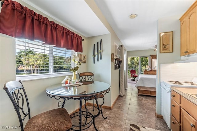 dining area with ceiling fan and light tile patterned flooring