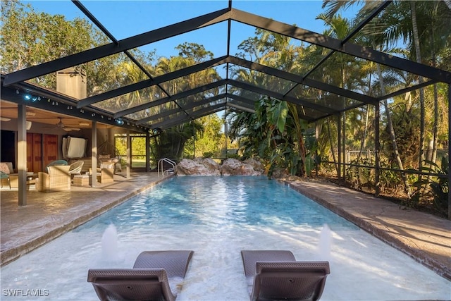 view of pool featuring ceiling fan, a lanai, and a patio