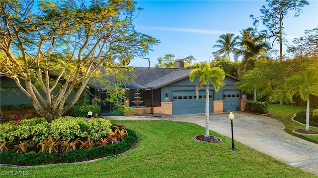 view of front of home with a front yard and a garage