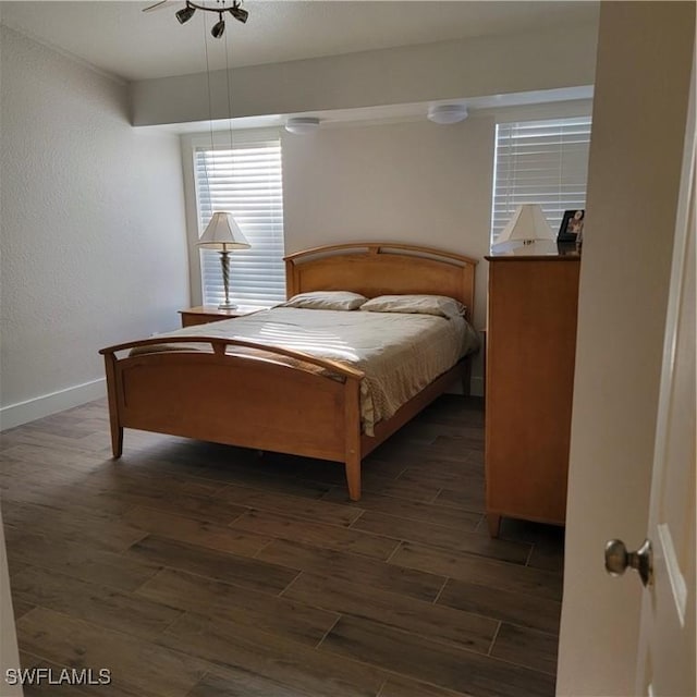 bedroom with ceiling fan and dark wood-type flooring