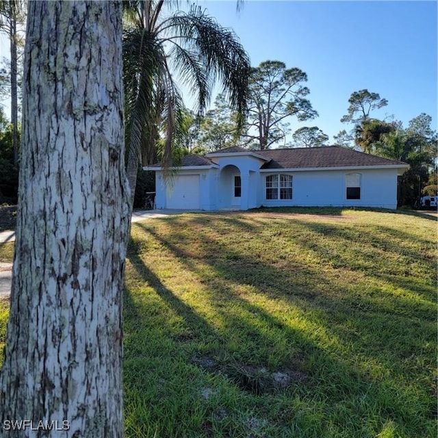 ranch-style house with a front lawn, an attached garage, and stucco siding