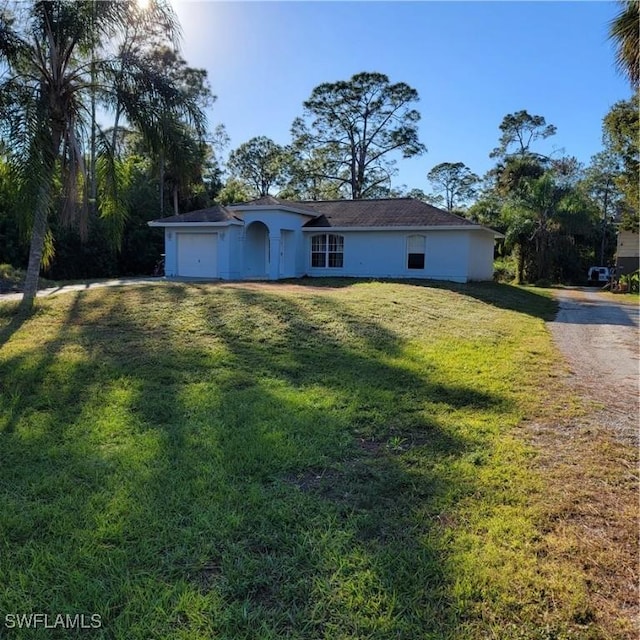 single story home with a front lawn and a garage