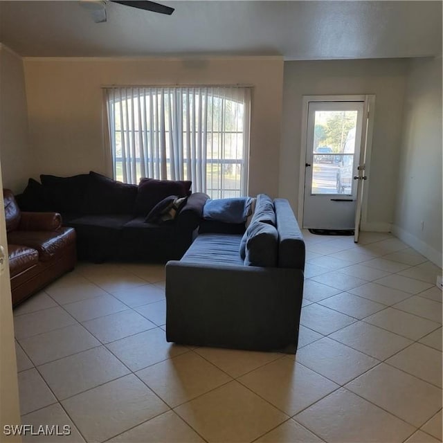 living room featuring ceiling fan and light tile patterned flooring