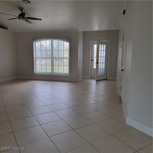 interior space with ceiling fan, a textured ceiling, and french doors