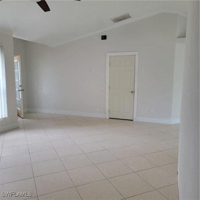 tiled spare room featuring ceiling fan and lofted ceiling