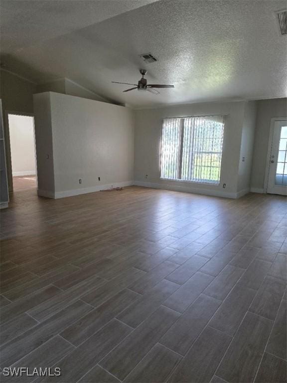 unfurnished room with wood finish floors, visible vents, ceiling fan, and a textured ceiling