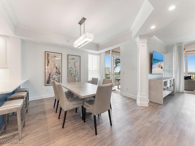 dining space featuring a healthy amount of sunlight, crown molding, and light hardwood / wood-style floors