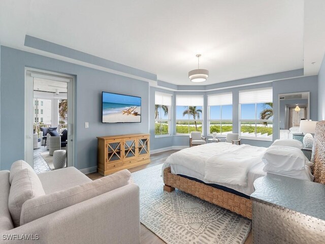 bedroom featuring hardwood / wood-style flooring and multiple windows