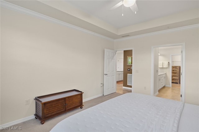 bedroom with ceiling fan, crown molding, light colored carpet, and ensuite bathroom