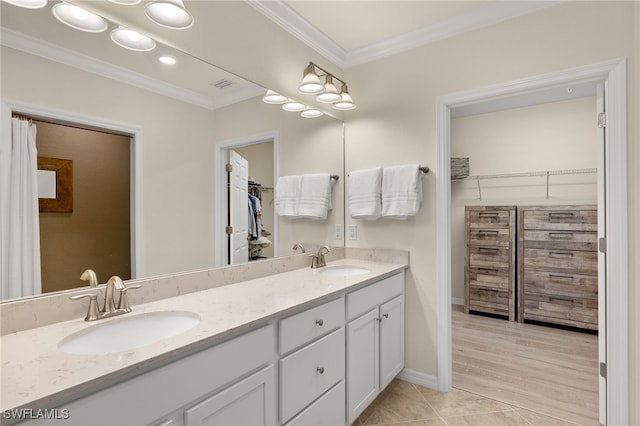 bathroom featuring hardwood / wood-style flooring, vanity, and crown molding