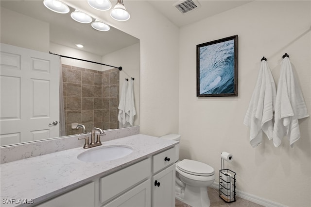 bathroom with vanity, toilet, and a shower