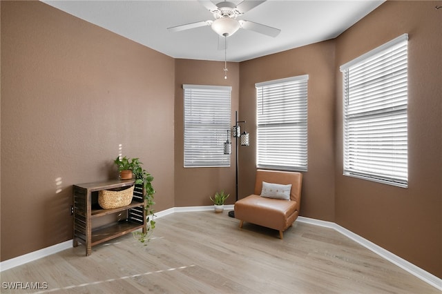 sitting room featuring ceiling fan and light hardwood / wood-style floors