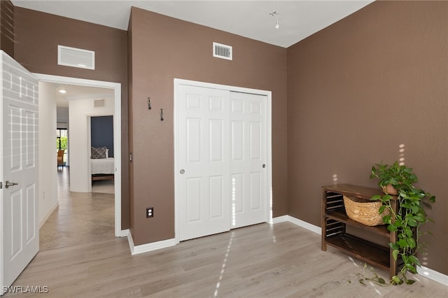 bedroom featuring a closet and light hardwood / wood-style flooring