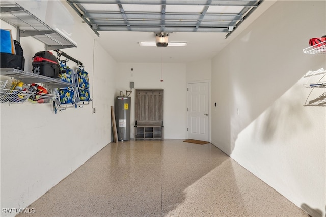 garage featuring electric water heater and a garage door opener