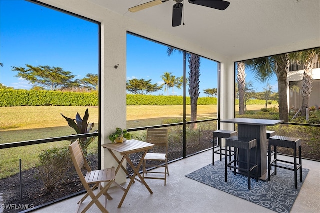 sunroom featuring ceiling fan