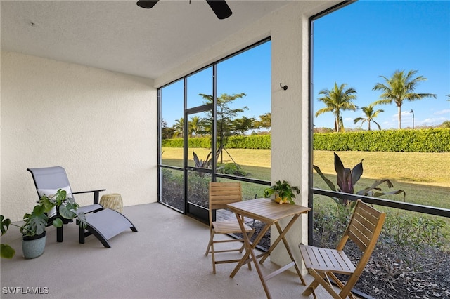 sunroom / solarium featuring ceiling fan