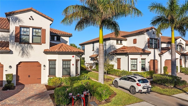 mediterranean / spanish-style home with a garage