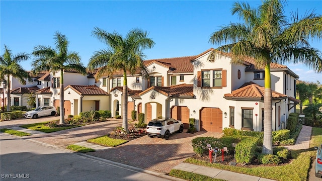 mediterranean / spanish-style home with a garage