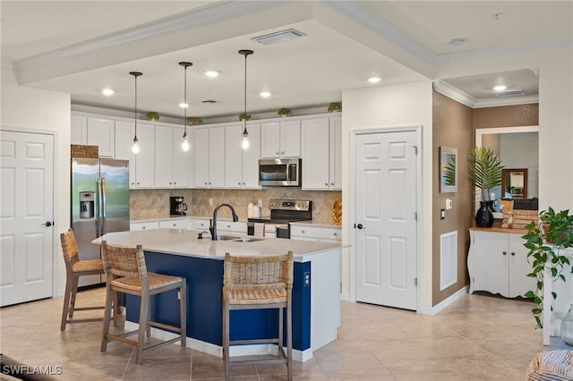 kitchen with white cabinets, appliances with stainless steel finishes, pendant lighting, and sink