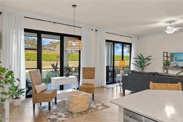 tiled living room with ceiling fan, a healthy amount of sunlight, and ornamental molding