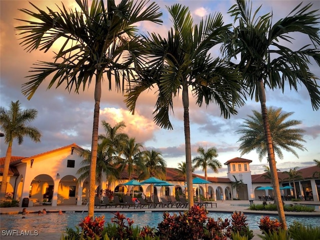 view of pool at dusk