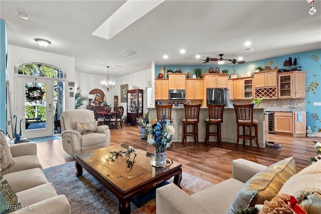 2270 Palo Duro Blvd, North Fort Myers, FL 33917 - living room featuring a chandelier, light wood-style flooring, bar, and recessed lighting