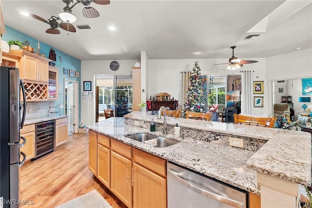 2270 Palo Duro Blvd, North Fort Myers, FL 33917 - kitchen featuring beverage cooler, stainless steel dishwasher, a ceiling fan, freestanding refrigerator, and open floor plan