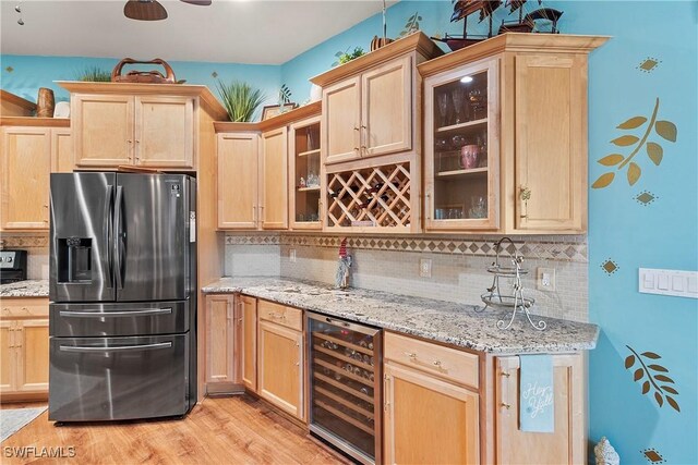 2270 Palo Duro Blvd, North Fort Myers, FL 33917 - kitchen featuring wine cooler, stainless steel refrigerator with ice dispenser, light brown cabinets, tasteful backsplash, and light wood-style floors