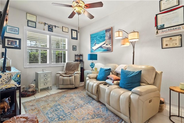 living area with ceiling fan and light tile patterned floors