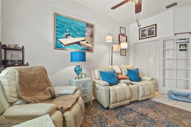 sitting room with tile patterned flooring and ceiling fan