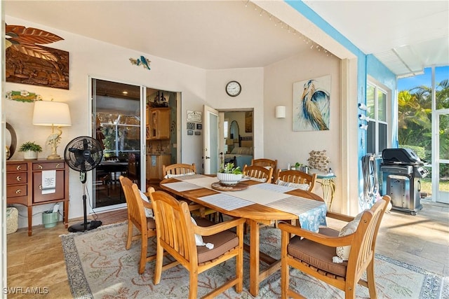 dining room with plenty of natural light and stone tile flooring