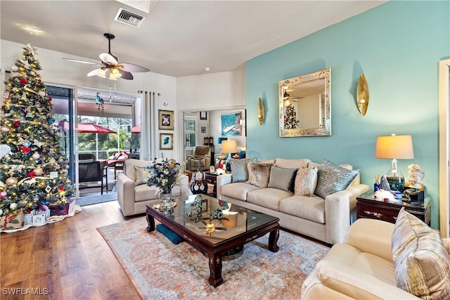 living room with ceiling fan and wood-type flooring