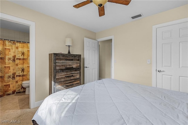 bedroom featuring ceiling fan and ensuite bathroom