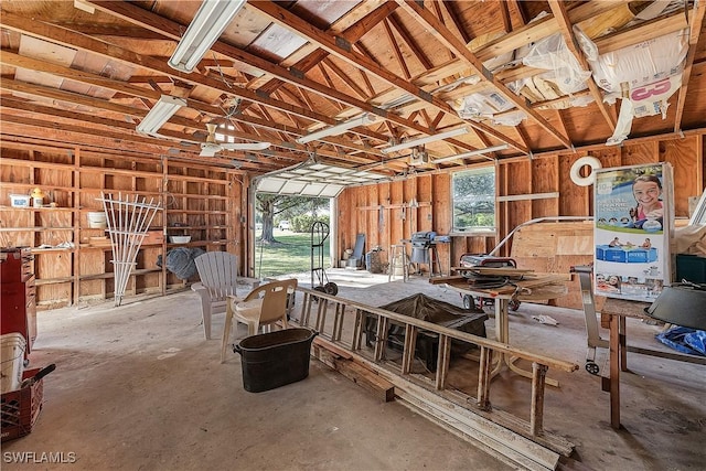 misc room with concrete floors and lofted ceiling