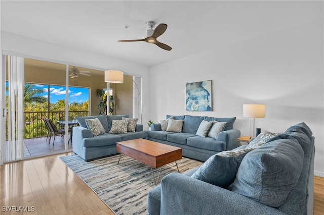 living room featuring ceiling fan and light wood-type flooring