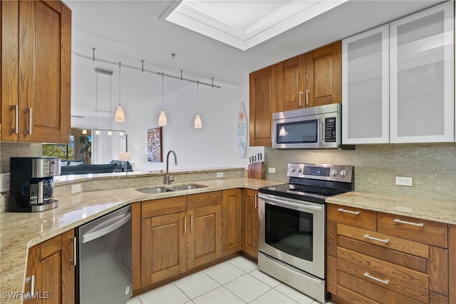 kitchen with stainless steel appliances, crown molding, sink, light tile patterned floors, and pendant lighting