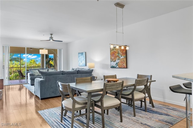 dining area featuring hardwood / wood-style flooring and ceiling fan