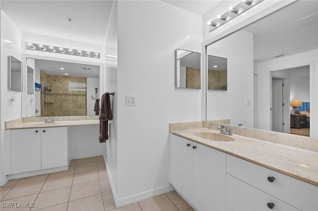 bathroom featuring tile patterned flooring, vanity, and walk in shower