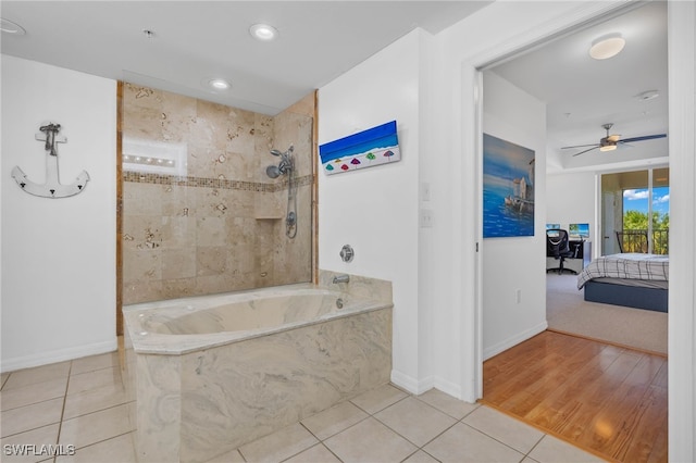 bathroom with hardwood / wood-style flooring and ceiling fan