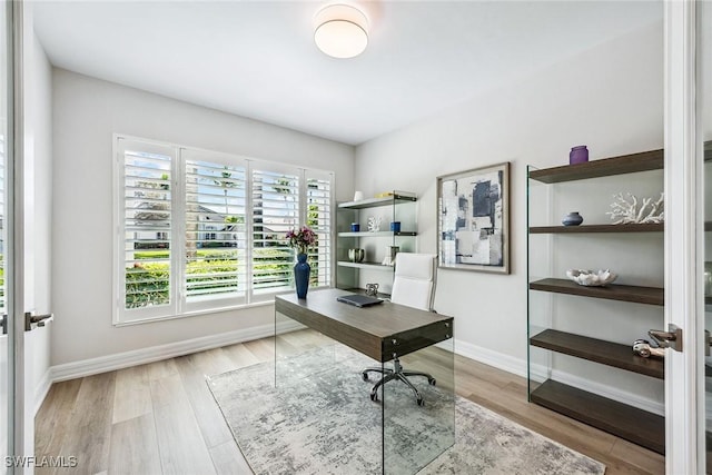 home office with french doors and light wood-type flooring