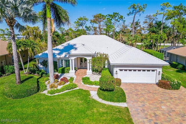 view of front of home with a garage and a front lawn