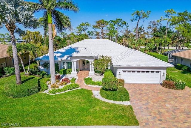 ranch-style house featuring a garage and a front yard