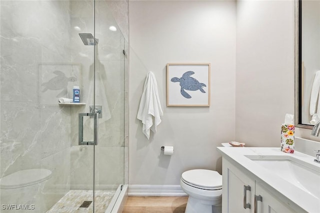 bathroom featuring vanity, hardwood / wood-style flooring, toilet, and walk in shower